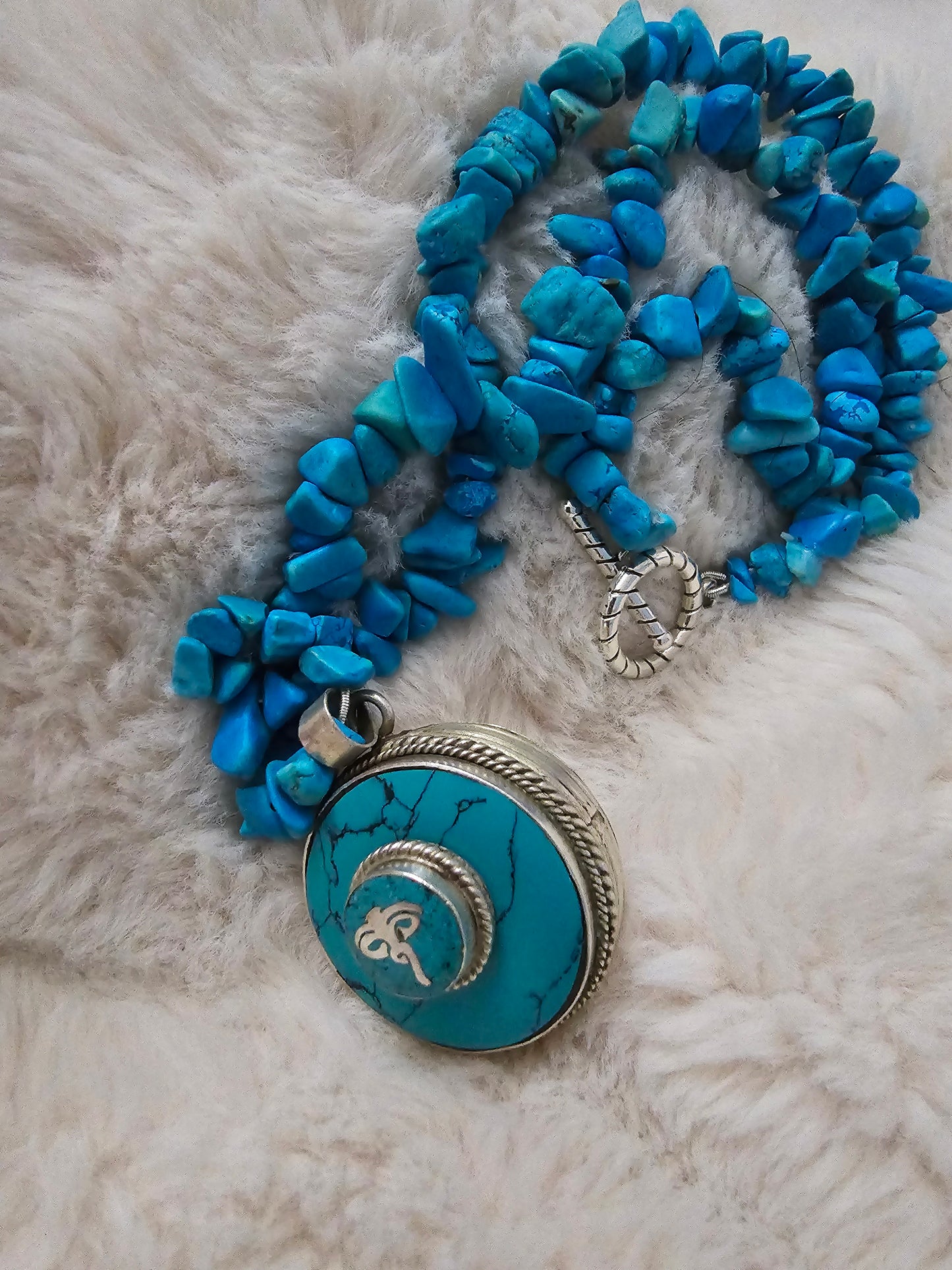 Turquoise and silver Buddahs eye pendant with hidden storage at the back. Hung on a chain of vintage natural real turquoise stones.