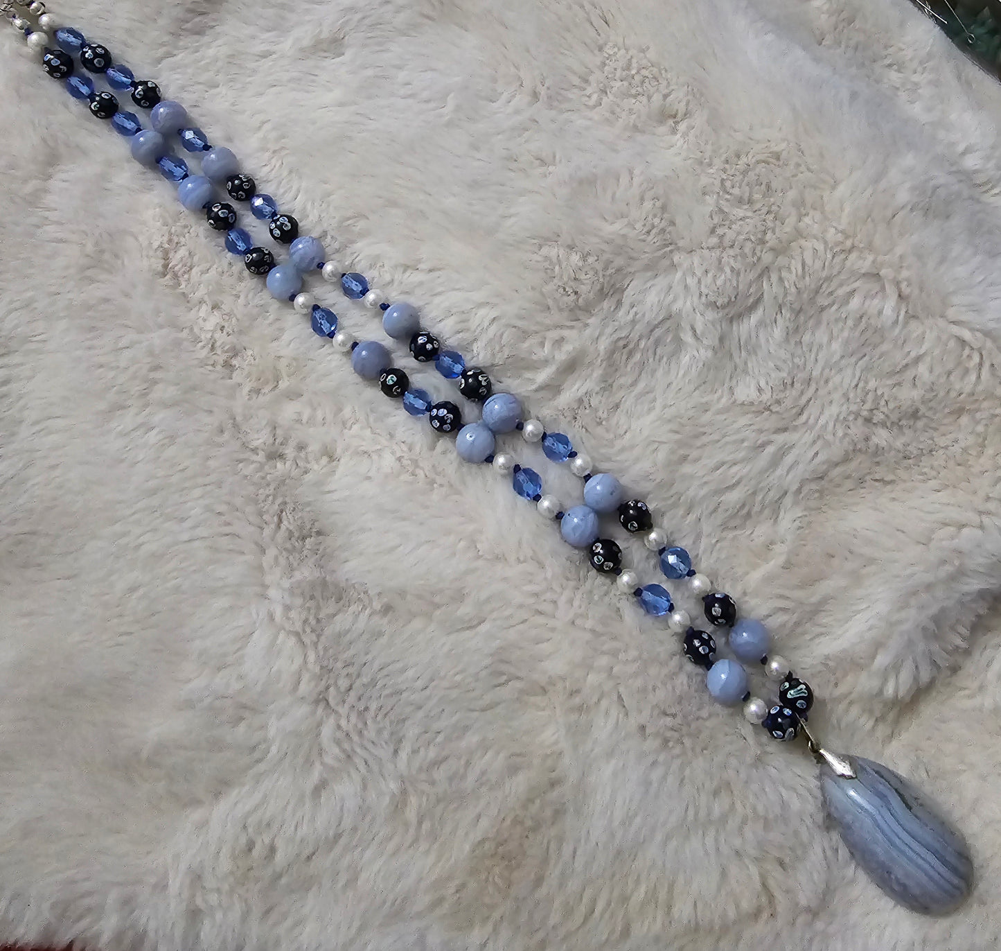 Beautiful hand knotted necklace of Blue lace agate; large vintage natural stone, small pearls, vintage AV blue glass crystal beads and vintage Chinese hand painted porcelain beads.