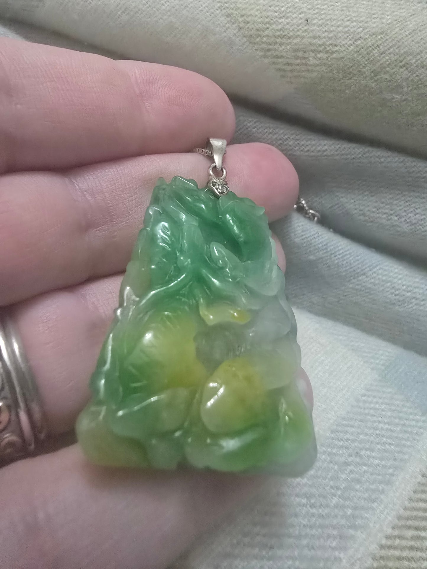 Apple Green and yellow jade Chinese year pendant. Fire horse and snake, very well carved.