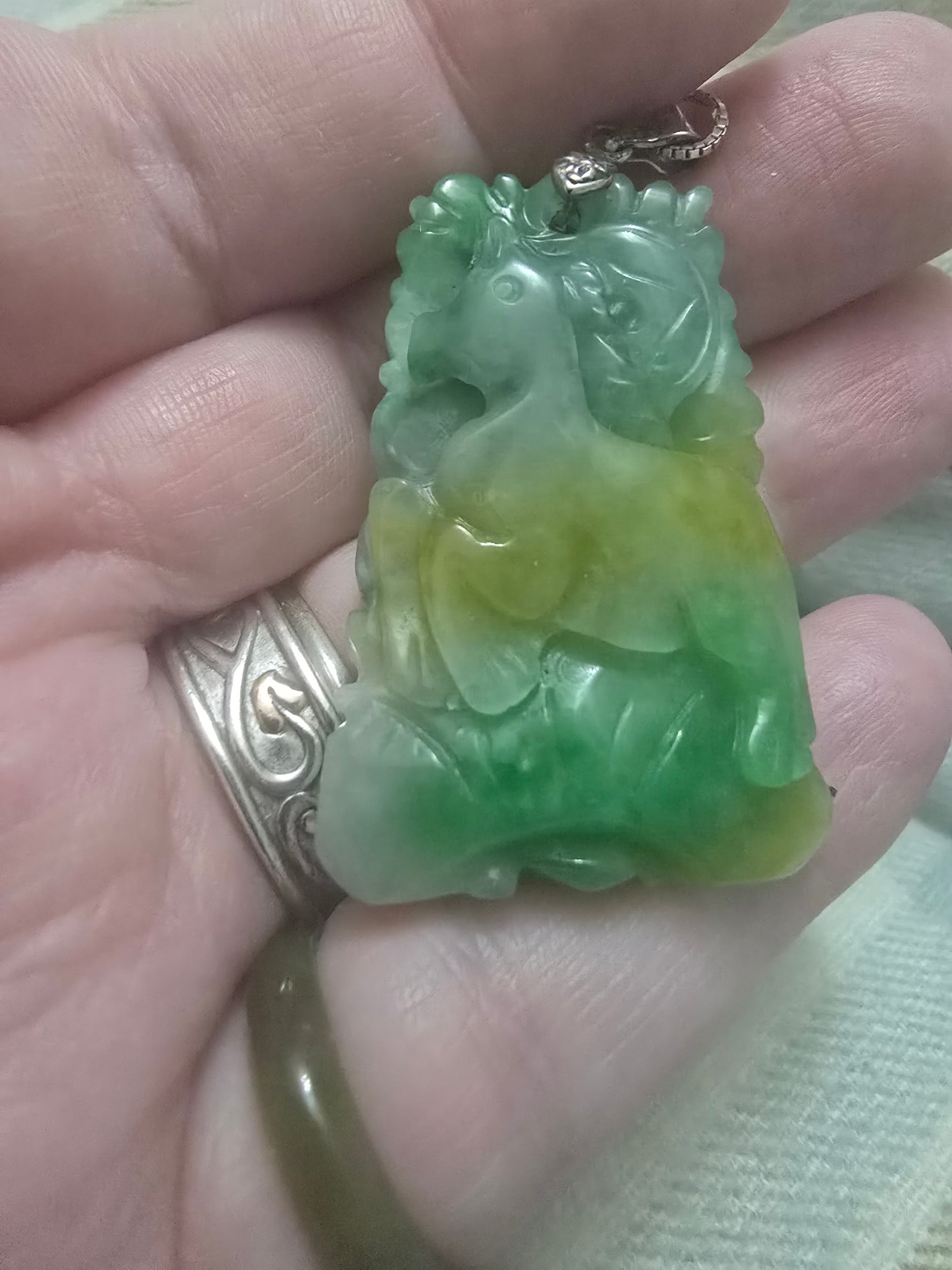 Apple Green and yellow jade Chinese year pendant. Fire horse and snake, very well carved.